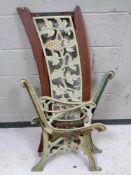 A pair of cast iron bench ends together with a cast iron bench back