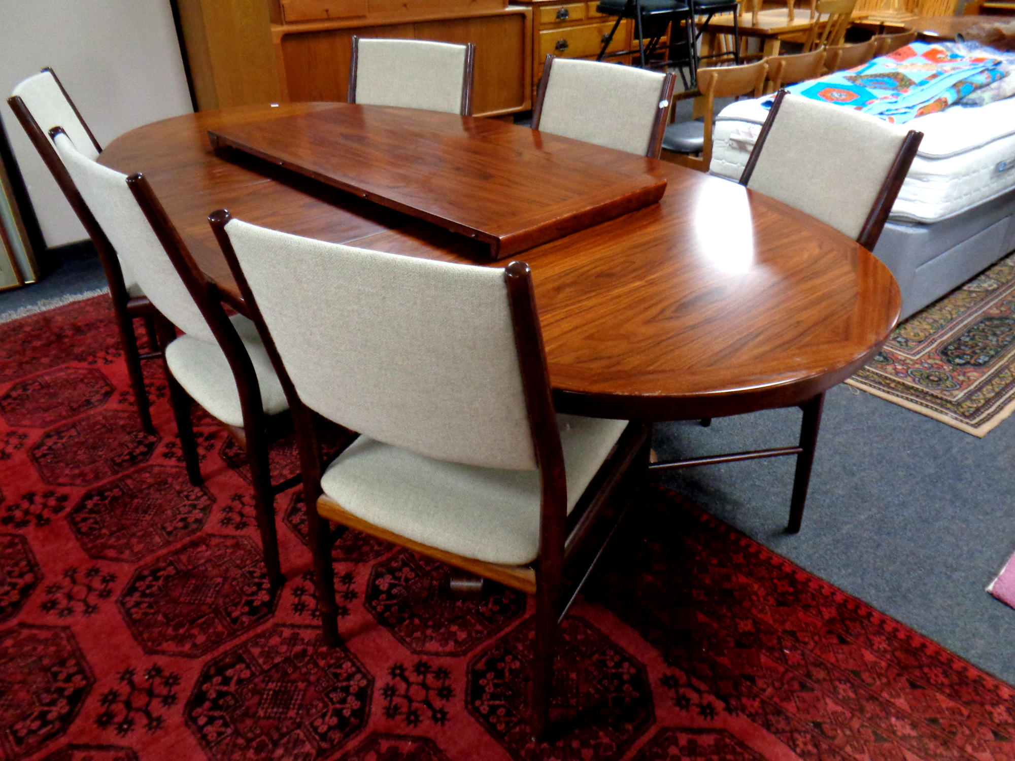 A 20th century Skovby rosewood oval extending dining table with two leaves together with a set of