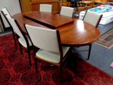 A 20th century Skovby rosewood oval extending dining table with two leaves together with a set of