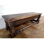 A duet refectory footstool in antique finish, length 76 cm.