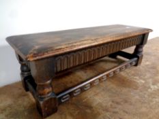A duet refectory footstool in antique finish, length 76 cm.