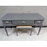 A Stag Minstrel three drawer painted dressing table with stool, width 120 cm.