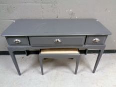 A Stag Minstrel three drawer painted dressing table with stool, width 120 cm.