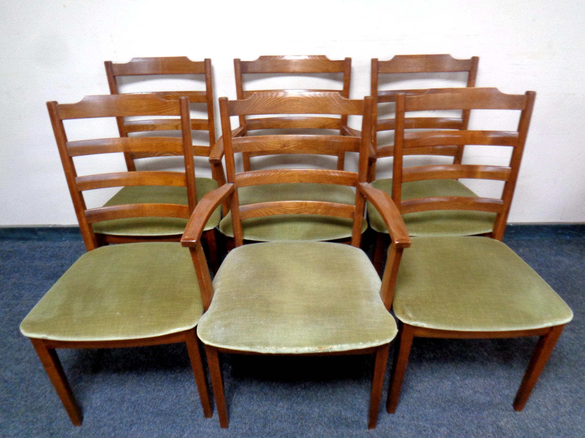 A set of six twentieth century teak G-plan ladder backed chairs comprising of two carvers and four