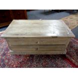 A pine coffee table fitted with four drawers, width 109 cm.