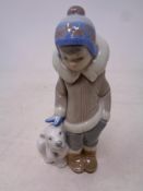 A Lladro figure Eskimo boy with polar bear cub