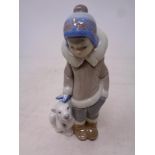 A Lladro figure Eskimo boy with polar bear cub