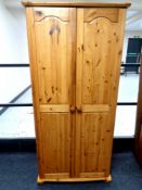 A contemporary pine double door wardrobe