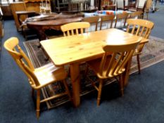 A pine kitchen table together with four chairs