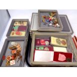 A quantity of Eastern European medals and badges in seven plastic storage boxes