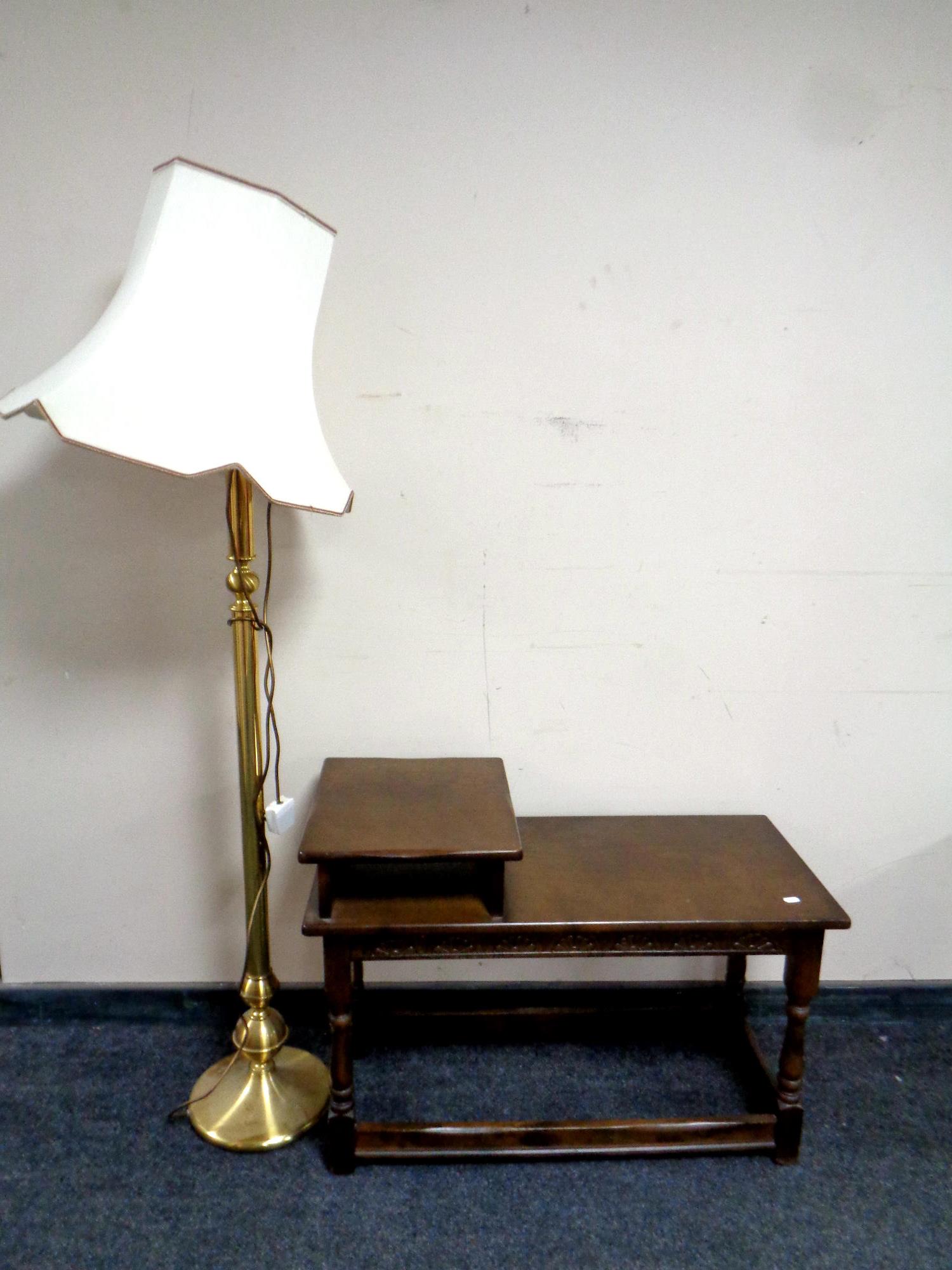 A telephone table in an oak finish together with a brass floor lamp with shade