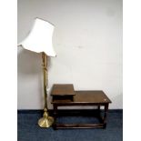 A telephone table in an oak finish together with a brass floor lamp with shade