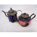 Two Chinese white metal and porcelain teapots (one with Cloisonne detail)
