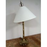 A brass table lamp with shade, height 76 cm.