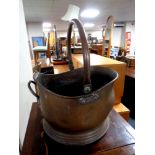 An antique copper coal bucket