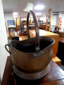 An antique copper coal bucket