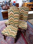 A set of three oak high backed dining chairs upholstered in tapestry fabric