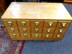 A twentieth century oak fifteen drawer index chest