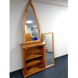 A set of pine open bookshelves together with two framed mirrors
