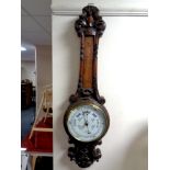 A late 19th century carved oak banjo barometer