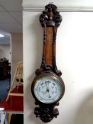 A late 19th century carved oak banjo barometer