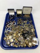 A tray of various costume jewellery, tie pins, cuff links, brooches,