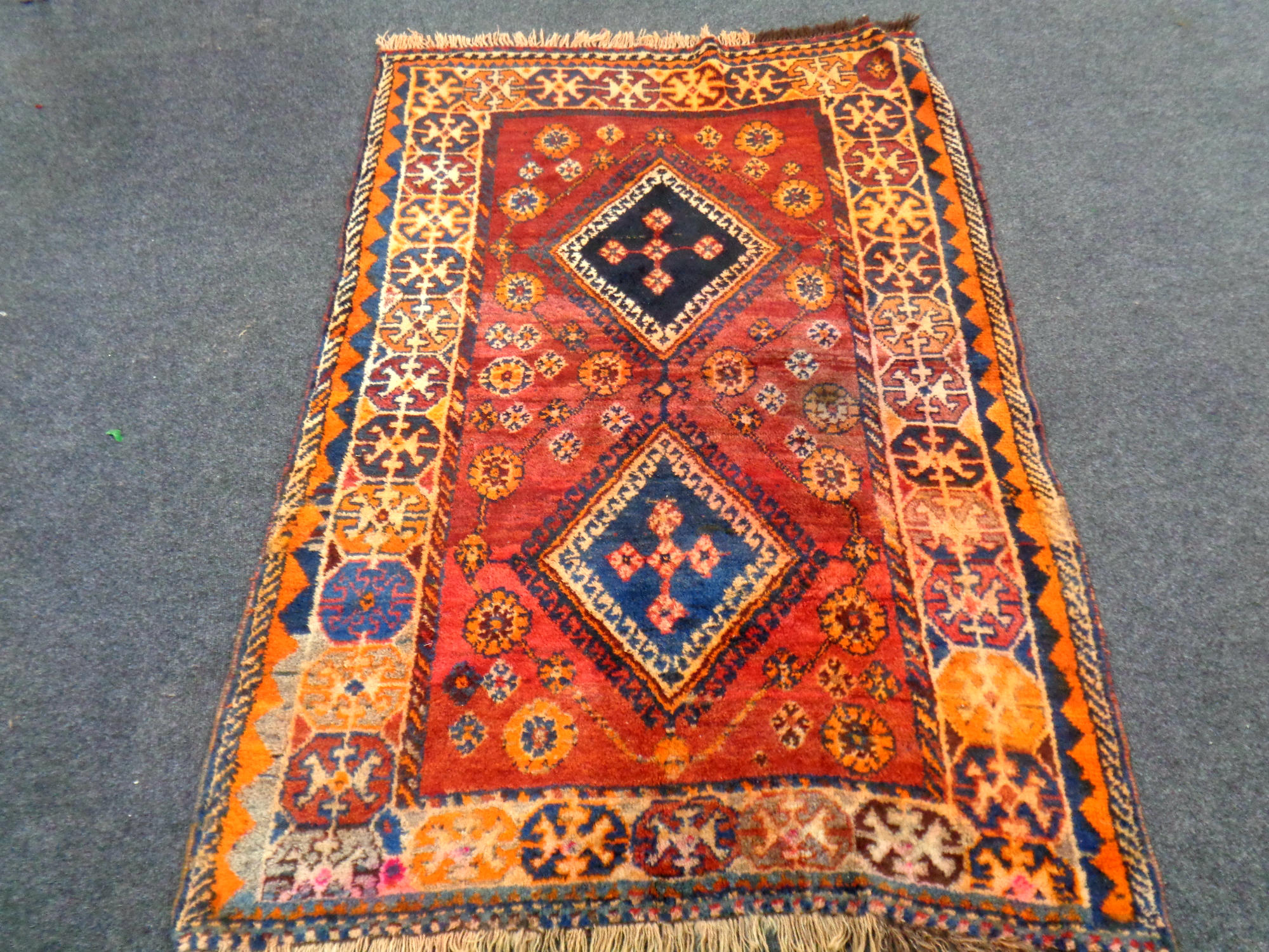 An Iranian rug on red ground,