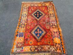 An Iranian rug on red ground,