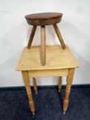 A stripped pine square topped occasional table together with a milking stool