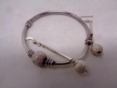 A silver bangle with matching earrings