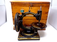 A scarce Victorian Nussey & Pilling 'The Improved Little Stranger' sewing machine in a pine case