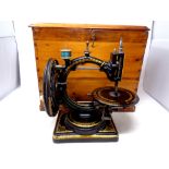 A scarce Victorian Nussey & Pilling 'The Improved Little Stranger' sewing machine in a pine case