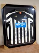 A Newcastle United 2014/15 shirt signed by the team,