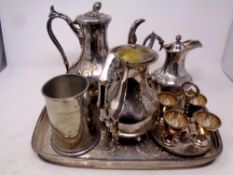 A silver plated tray containing plated wares to include Chinese teapot together with further teapot