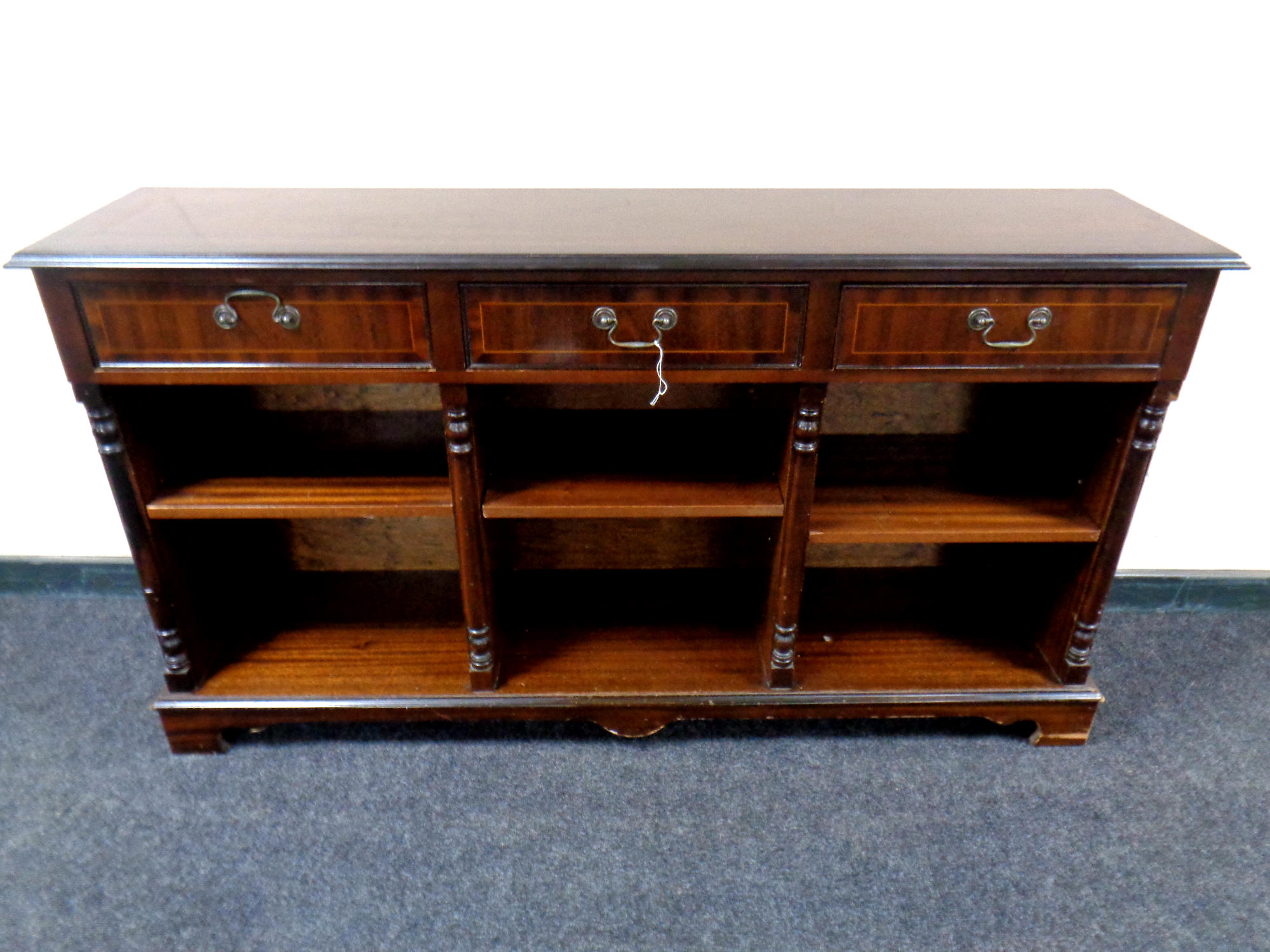 A set of inlaid mahogany open bookshelves fitted three drawers above,