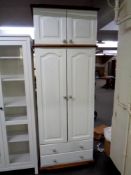 A painted pine double door nursery wardrobe, fitted two drawers beneath,