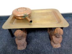 A pair of 19th century figural cast iron fire dogs together with an eastern brass tray on stand and