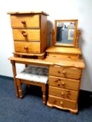 A pine single pedestal four drawer dressing table with mirror and stool together with similar three