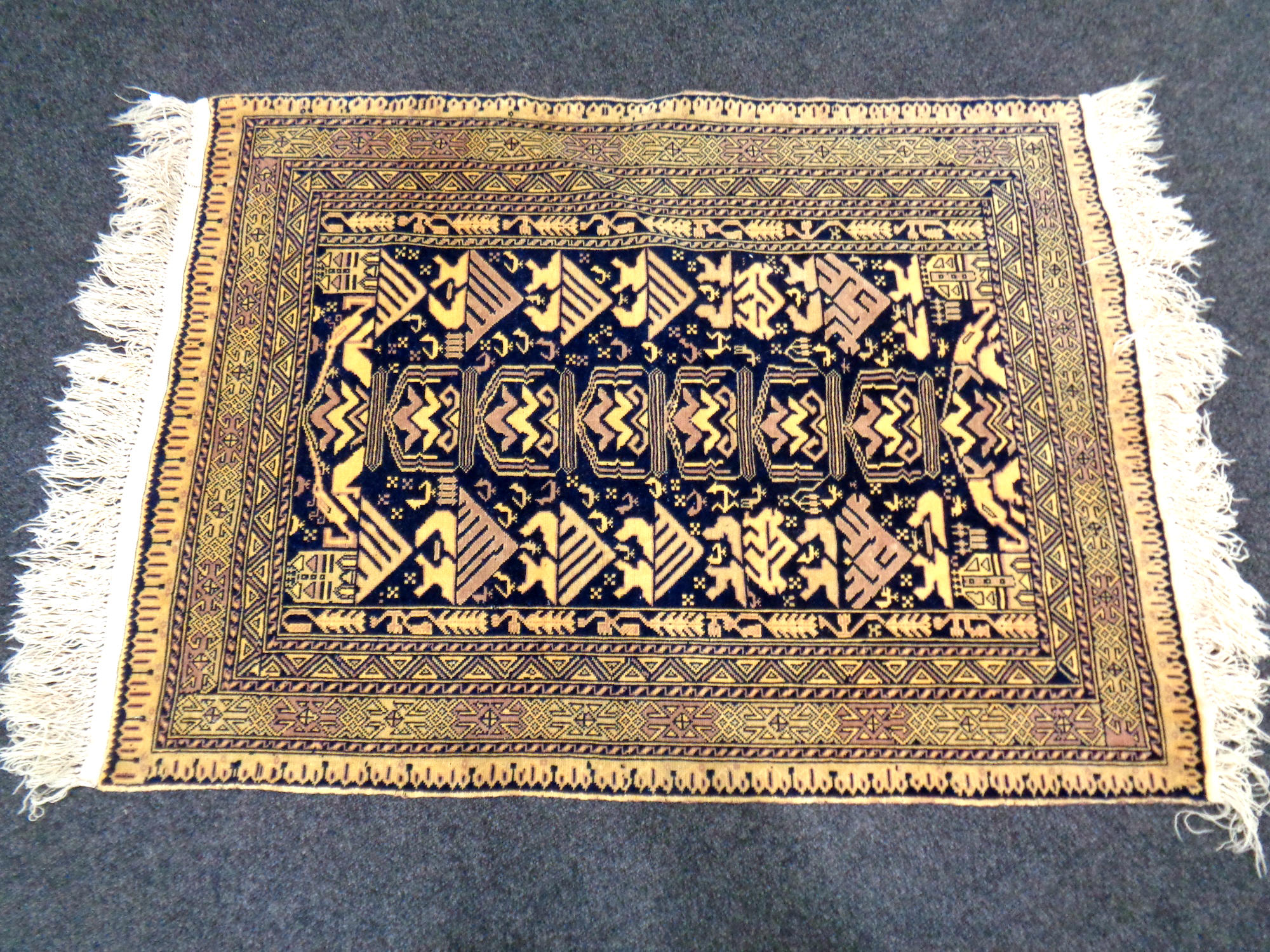 A fringed Afghan rug 172 cm x 196 cm