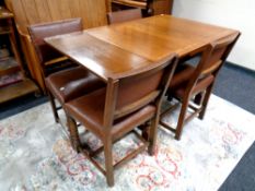 A 20th century oak pull out dining table together with a set of four studded leather upholstered