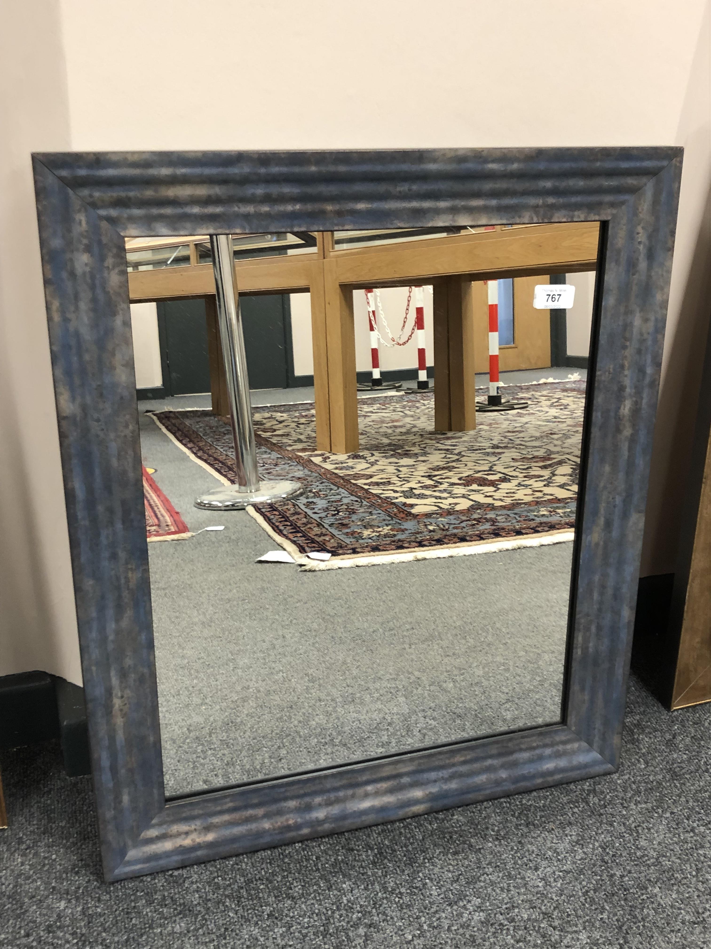 A modern mirror in blue tone frame