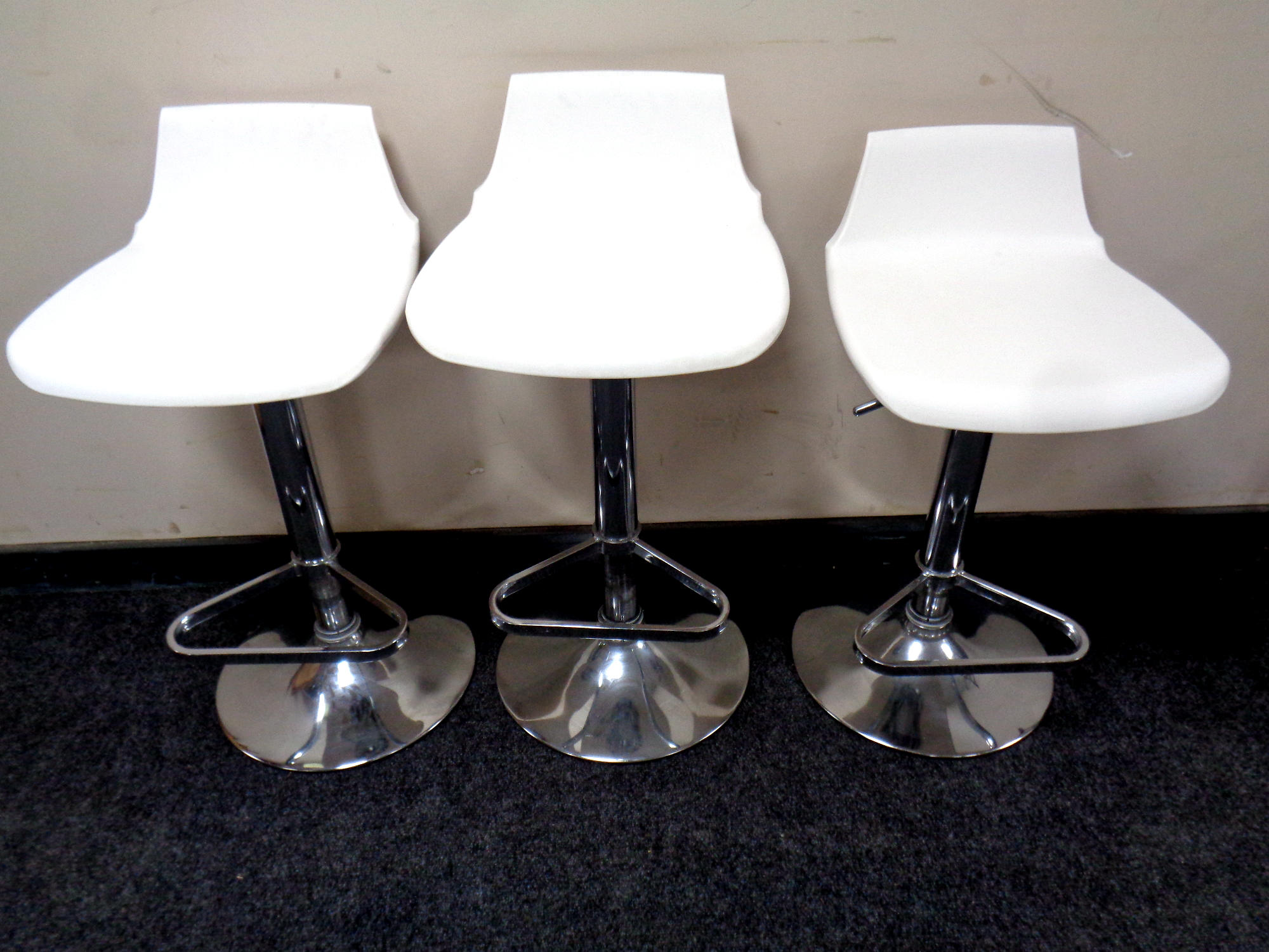 A set of three gas lift breakfast bar chairs