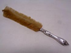 A silver handled brush