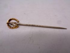 A 9ct gold headed stick pin