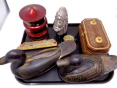 A tray containing wooden duck ornaments, wicker casket,