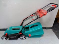 A Bosch Rotak 34-13 electric lawn mower with grass box and lead