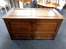 A 19th century oak panelled blanket box fitted two drawers beneath,