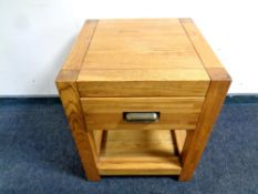 A contemporary oak two tier lamp table fitted a drawer,