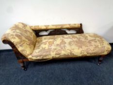 A 19th century carved mahogany chaise longue upholstered in a paisley patterned print