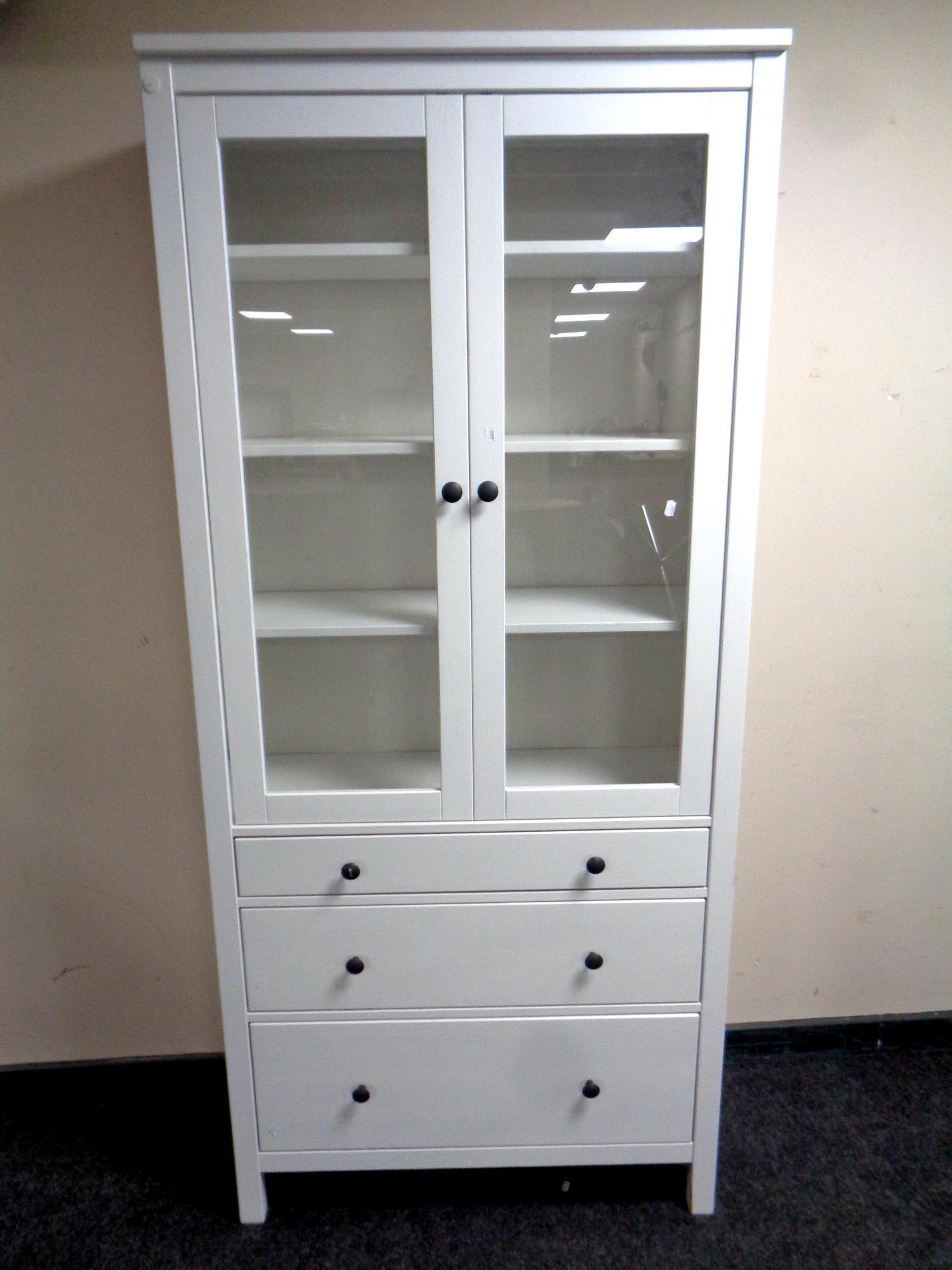 An Ikea painted pine double door bookcase fitted three drawers beneath